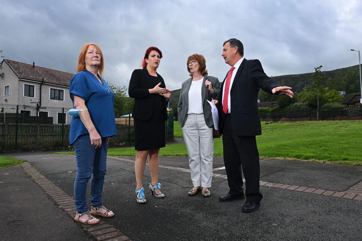 Labour MP and Northern Ireland shadow secretary of state Louise Haigh meets Ballymurphy families spokesman John Teggart and fellow Ballymurphy family members at Manse field, the scene of several of the Ballymurphy killings, in Belfast, Northern Ireland, on Aug. 13, 2021. (Charles McQuillan/Getty Images)