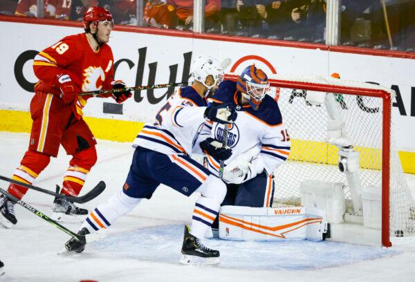 Edmonton Oilers goalie Mikko Koskinen (R), looks back at the puck on a goal by Calgary Flames forward Matthew Tkachuk during the second period of Game 1 of an NHL hockey second-round playoff series in Calgary, Alberta, on May 18, 2022. (Jeff McIntosh/The Canadian Press via AP)
