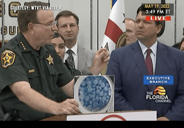 Polk County Sheriff Grady Judd holds a picture showing what two milligrams of fentanyl looks like in Lakeland, Fla., on May 19, 2022. (WTVT via The Florida Channel/Screenshot via The Epoch Times)