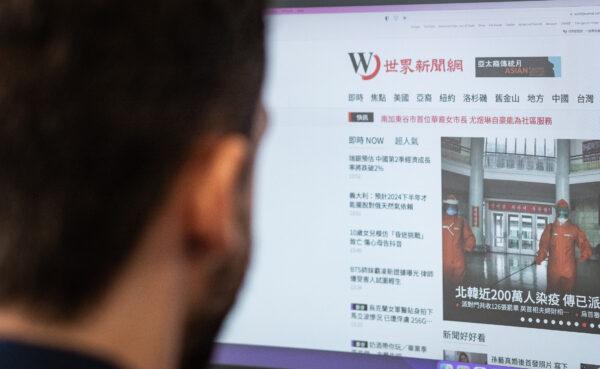 A man looks online at the World Journal newspaper in Irvine, Calif., on May 19, 2022. (John Fredricks/The Epoch Times)