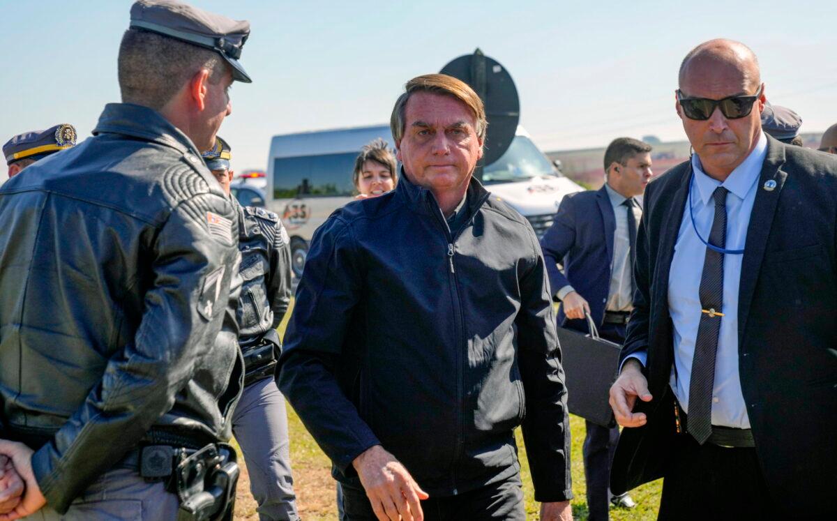 Brazilian President Jair Bolsonaro arrives to a resort hotel where he is expected to meet with Elon Musk in Porto Feliz, Brazil, on May 20, 2022. The Telsa and SpaceX chief executive officer tweeted that he was in Brazil to help bring internet service to rural schools in the Amazon and to help monitor the Amazon environmentally. (AP Photo/Andre Penner)