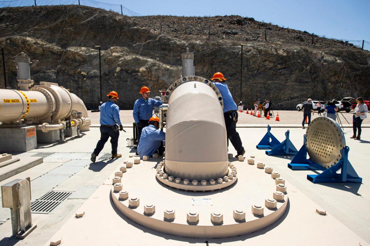 Southern Nevada Water Authority maintenance mechanics install a spacer flange after removing an energy dissipator at the Low Lake Level Pumping Station at Lake Mead National Recreation Area on  April 27, 2022. (Chase Stevens/Las Vegas Review-Journal via AP)