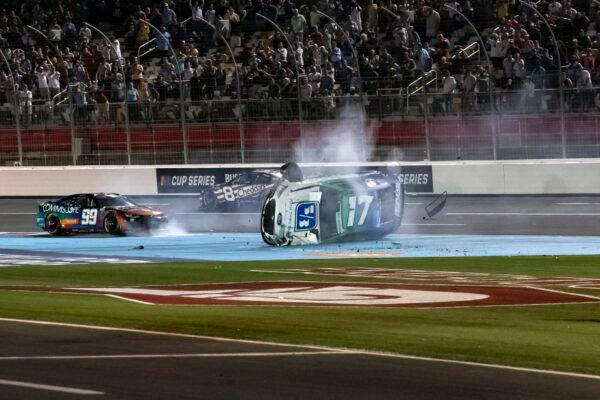 Chris Buescher (17) and Daniel Suarez (99) crash during a NASCAR Cup Series auto race at Charlotte Motor Speedway in Concord, N.C., on May 29, 2022. (Matt Kelley/AP Photo)