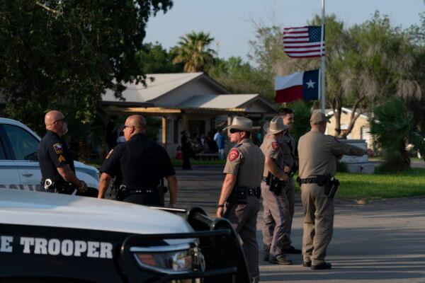 Law enforcement personnel stand outside a funeral home during a visitation for Amerie Garza, a 10-year-old victim who was killed in the elementary school shooting in Uvalde, Texas, on May 30, 2022. (Jae C. Hong/AP Photo)