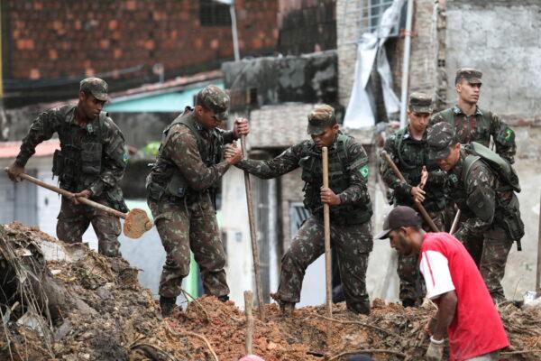 Army officers work on the site where a house collapsed due to a landslide caused by heavy rains at Jardim Monte Verde, in Ibura neighborhood, in Recife, Brazil, on May 29, 2022. (Diego Nigro/Reuters)