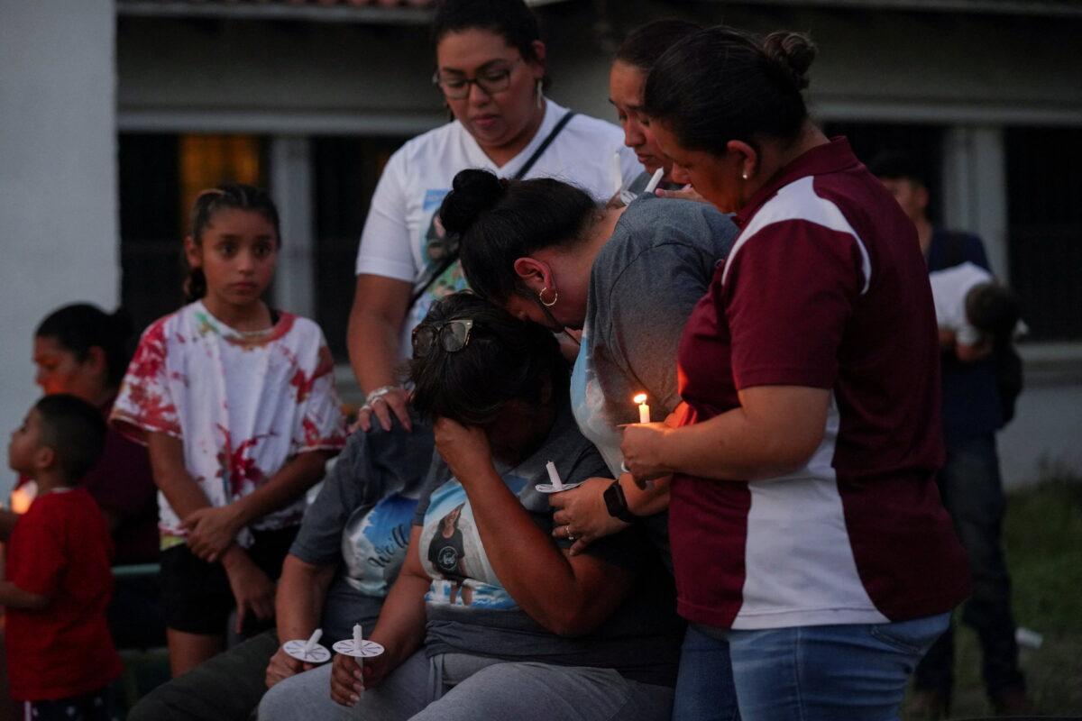 Relatives of Alexandria Aniyah Rubio 'Lexie' mourn her death during a vigil to remember the victims of the deadliest U.S. school shooting in nearly a decade resulting in the death of 19 children and two teachers, at a memorial at Robb Elementary School in Uvalde, Texas, U.S. May 30, 2022. (Reuters/Veronica G. Cardenas)