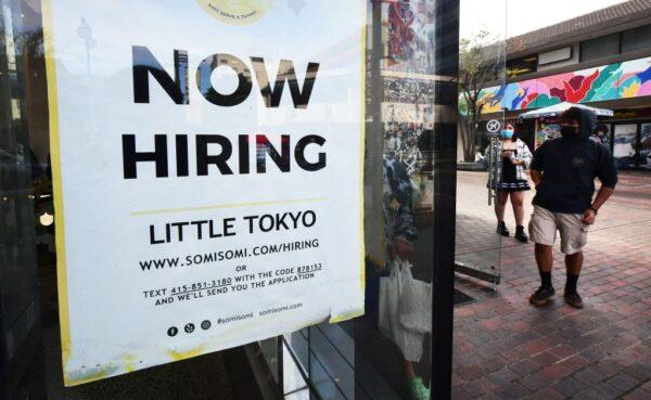 A "now hiring" sign is posted in the window of an ice cream shop in Los Angeles, California on January 28, 2022. (Frederic J. Brown/AFP via Getty Images)