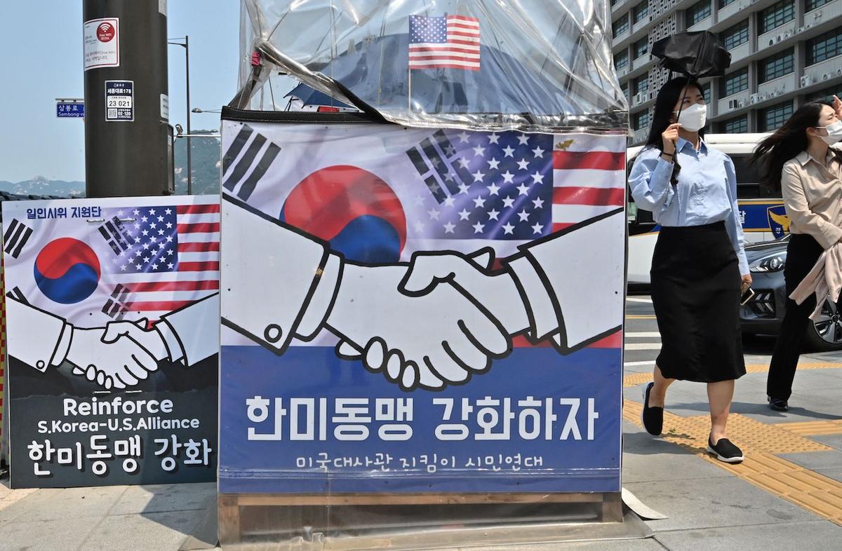 Pedestrians walk past banners calling for the strengthening of the South Korea–U.S. alliance near the U.S. embassy in Seoul, South Korea, on May 20, 2022, ahead of U.S. President Joe Biden's visit to South Korea. (Jung Yeon-je/AFP via Getty Images)