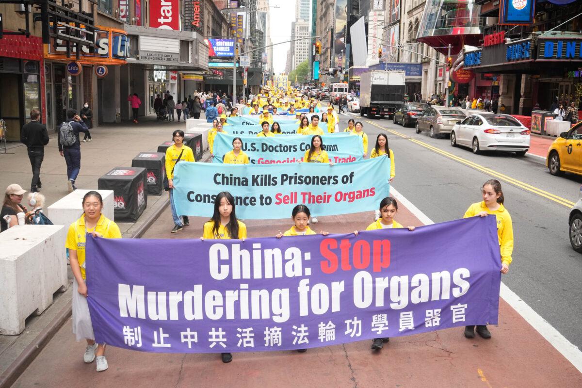 Falun Gong practitioners participate in a parade marking the 30th anniversary of the spiritual discipline's introduction to the public in New York on May 13, 2022. (Larry Dye/The Epoch Times)