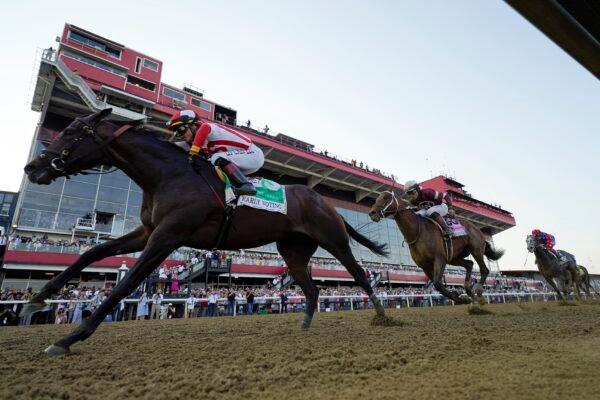 Jose Ortiz (L) atop Early Voting edges out Joel Rosario (2nd R) atop Epicenter and Brian Hernandez Jr. (R) atop Creative Minister, to win during the 147th running of the Preakness Stakes horse race at Pimlico Race Course in Baltimore on May 21, 2022. (Julio Cortez/AP Photo)