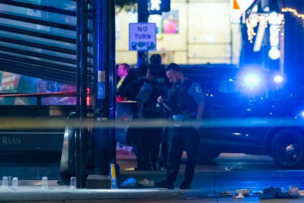 Police work at the scene of a shooting near East Chicago Avenue and North State Street in the Near North Side neighborhood in Chicago on May 19, 2022. (Tyler Pasciak LaRiviere/Chicago Sun-Times via AP)