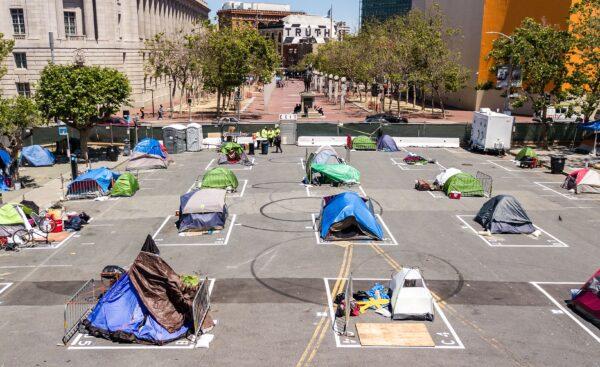 Rectangles are painted on the ground to encourage homeless people to keep social distancing at a city-sanctioned homeless encampment across from City Hall in San Francisco, Calif., on May 22, 2020, amid the COVID pandemic. (Josh Edelson/AFP via Getty Images)