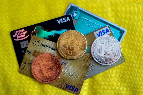 A picture shows a visual representation of the digital crypto-currency Bitcoin next to Visa cards, at the "Bitcoin Change" shop in the Israeli city of Tel Aviv on Feb. 6, 2018. (JACK GUEZ/AFP via Getty Images)