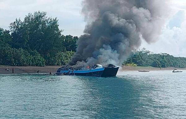 Smoke billows from ferry ship M/V Mercraft 2 as it was towed near an island on Real town, Quezon province, Philippines on May 23, 2022. (Philippine Coast Guard via AP Photo)