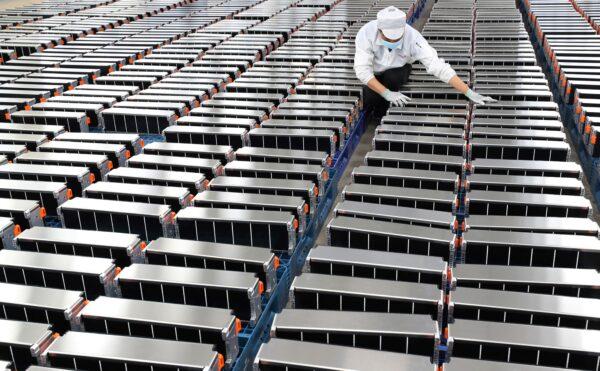 A worker with car batteries at a factory for Xinwangda Electric Vehicle Battery Co. Ltd., which makes lithium batteries for electric cars and other uses, in Nanjing in China's eastern Jiangsu Province, on March 12, 2021. (STR/AFP via Getty Images)