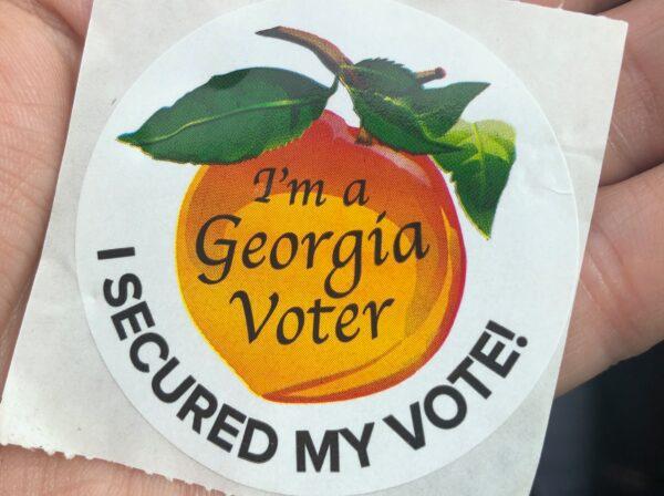 Many Georgia voters wore these stickers as they left voting precincts on May 24, 2022. (Nanette Holt/The Epoch Times)