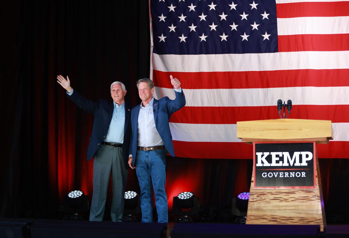 Georgia Gov. Brian Kemp (R) stands with former U.S. Vice President Mike Pence at a campaign event at the Cobb County International Airport in Kennesaw, Ga., on May 23, 2022. (Joe Raedle/Getty Images)