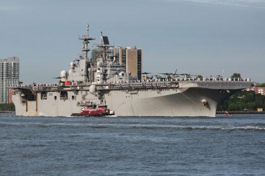 USS Bataan is escorted by one of several tugs to her dock at Manhattan's Pier 88 on May 25. (Richard Moore/The Epoch Times)