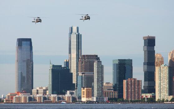 Black Hawk helicopters patrolled the Hudson River during the naval parade on May 25, 2022. (Richard Moore/The Epoch Times)