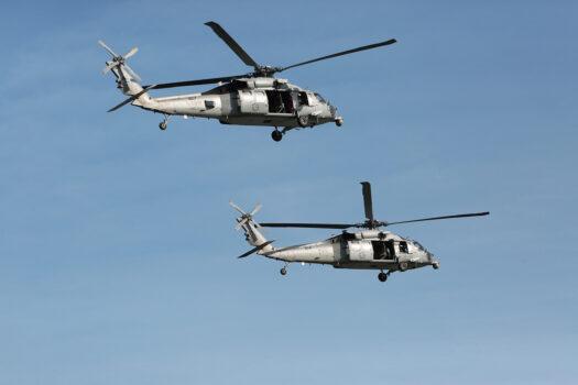 Black Hawk helicopters completed long loops above the Hudson River in New York while keeping an eye on the naval vessels heading along the waterway. (Richard Moore/The Epoch Times)