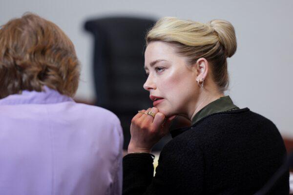 Actress Amber Heard reacts at the courtroom during actor and her ex-husband Johnny Depp's defamation case against her, at the Fairfax County Circuit Courthouse in Fairfax, Va., on May 25, 2022. (Evelyn Hockstein/Reuters)