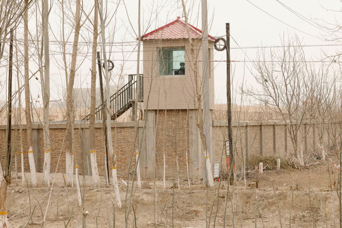 A security person watches from a guard tower around a detention facility in Yarkent County in northwestern China's Xinjiang Uyghur Autonomous Region on March 21, 2021. Allegations of human rights abuses in China's northwest Xinjiang region are the dominant issue on a visit by the United Nations' top rights official that starts on May 23, 2022. (Ng Han Guan/AP Photo)