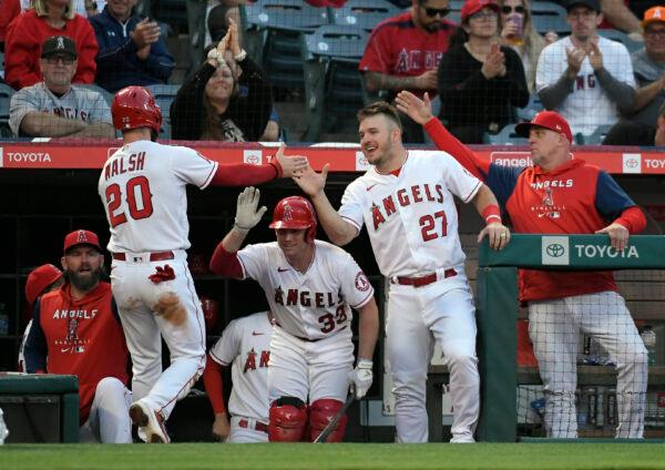 ANAHEIM, CA - MAY 24: Jared Walsh #20 of the Los Angeles Angels is congratulated by Mike Trout #27 and Max Stassi #33 after scoring a run against the Texas Rangers during the fourth inning at Angel Stadium of Anaheim on May 24, 2022 in Anaheim, California. (Photo by Kevork Djansezian/Getty Images)