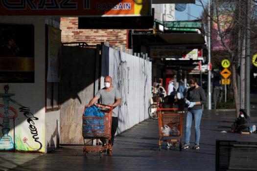 Shoppers are seen wearing face masks in the district of Fairfield in Sydney, Australia, on July 30, 2022. (Lisa Maree Williams/Getty Images)
