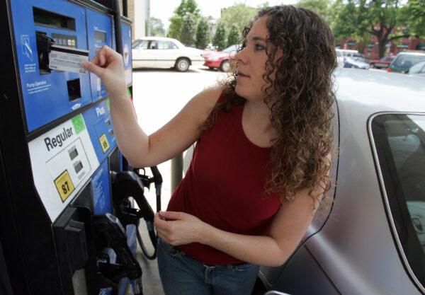 Amy Foley of Washington, DC, swipes her credit card as she prepares to fill her car with gas at an Exxon station on Capitol Hill in Washington, DC on May 23, 2007. (Saul Loeb/AFP via Getty Images)