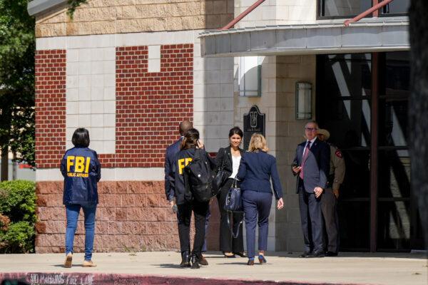 FBI public affairs officials arrive at the Uvalde High School auditorium for an update with state and local officials the day after a mass shooting at Robb Elementary, in Uvalde, Texas, on May 25, 2022. (Charlotte Cuthbertson/The Epoch Times)