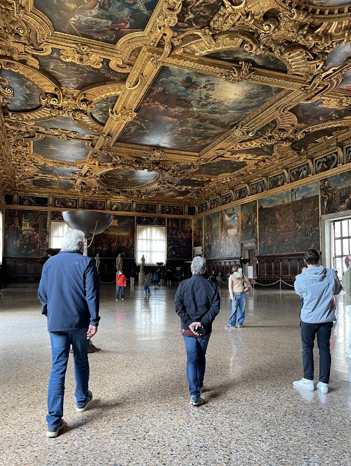 Guests absorb the impact of powerful gold friezes above the Great Council's meeting room in Venice's famed Doge's Palace. (Photo courtesy of Lesley Sauls Frederikson.)