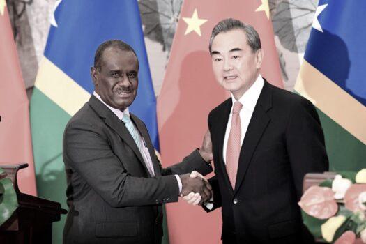 Solomon Islands Foreign Minister Jeremiah Manele (L) shakes hands with Chinese State Councilor and Foreign Minister Wang Yi to mark the establishment of diplomatic ties between the two nations at the Diaoyutai State Guesthouse in Beijing, China on September, 2019. (Naohiko Hatta - Pool/Getty Images)