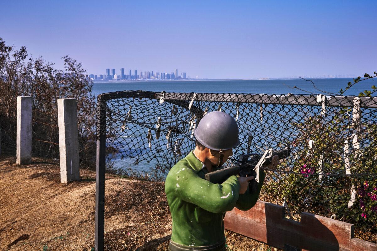 A figure of a Kuomintang soldier is seen in the foreground, with the Chinese city of Xiamen in the background, on February 04, 2021 in Lieyu, an outlying island of Kinmen that is the closest point between Taiwan and China. (An Rong Xu/Getty Images)