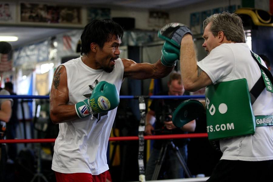 Manny Pacquiao (L) hitting mitts with famed boxing trainer Freddie Roach in "Manny." (Gravitas Ventures/Universal Pictures)
