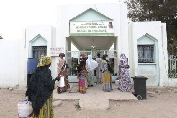 Visitors stand in front of the Mame Abdoul Aziz Sy Dabakh Hospital, where 11 babies died following an electrical fault in Tivaouane, Senegal, on May 26, 2022. (Seyllou/AFP via Getty Images)