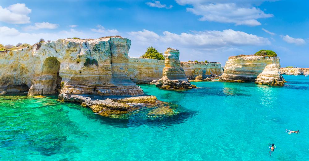 Swimmers enjoy the waters off the Stacks of Torre Sant Andrea on the Salento coast. (Balate Dorin/Shutterstock)