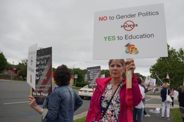 Parents protest Fairfax County Public Schools’ latest pro-transgender push in school policies outside of the county school board meeting in Falls Church, Va., on May 26, 2022. (Terri Wu/The Epoch Times)