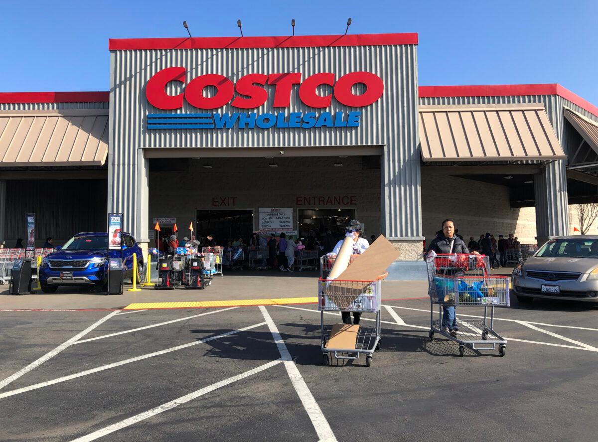 Costco customers push shopping carts through the parking lot of a Costco store in Richmond, Calif., on March 13, 2020. (Justin Sullivan/Getty Images)