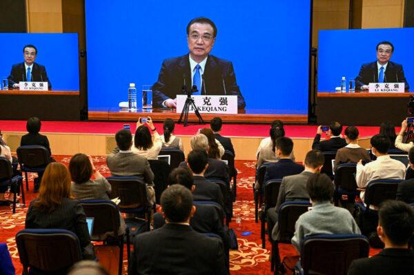 Chinas Premier Li Keqiang speaks via live video transmission during a press conference after the closing session of the National People's Congress at the Great Hall of the People in Beijing on March 11, 2021. (Noel Celis/AFP via Getty Images)