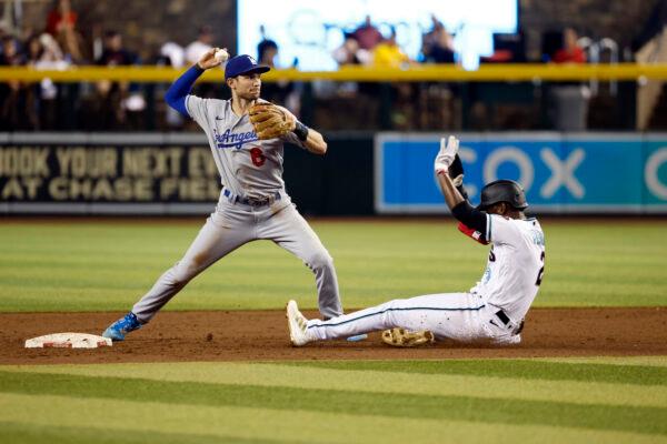 Trea Turner #6 of the Los Angeles Dodgers attempts to turn a double play over Geraldo Perdomo #2 of the Arizona Diamondbacks during the third inning at Chase Field, in Phoenix, on May 26, 2022. (Chris Coduto/Getty Images)