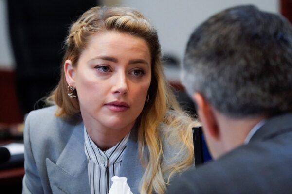 Actress Amber Heard talks with her legal team in the courtroom during ex-husband Johnny Depp's defamation case against her at the Fairfax County Circuit Courthouse in Fairfax, Va., on May 27, 2022. (Steve Helber/Pool via Reuters)