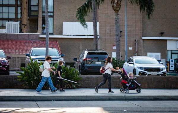 A family walks towards the parking area after leaving the 2022 Star Wars Celebration in Anaheim, Calif., on May 26, 2022. (John Fredricks/The Epoch Times)