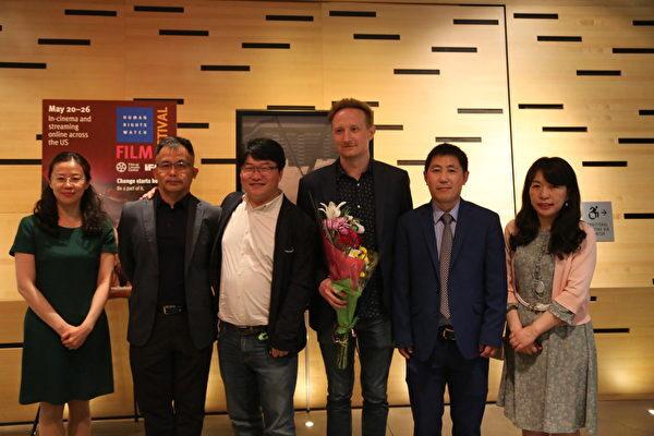A group photo of people from Changchun with director Jason Loftus (third R) and animation artist Daxiong (third L) at the premiere of "Eternal Spring" in New York on May 24, 2022. (Shi Ping/ The Epoch Times)