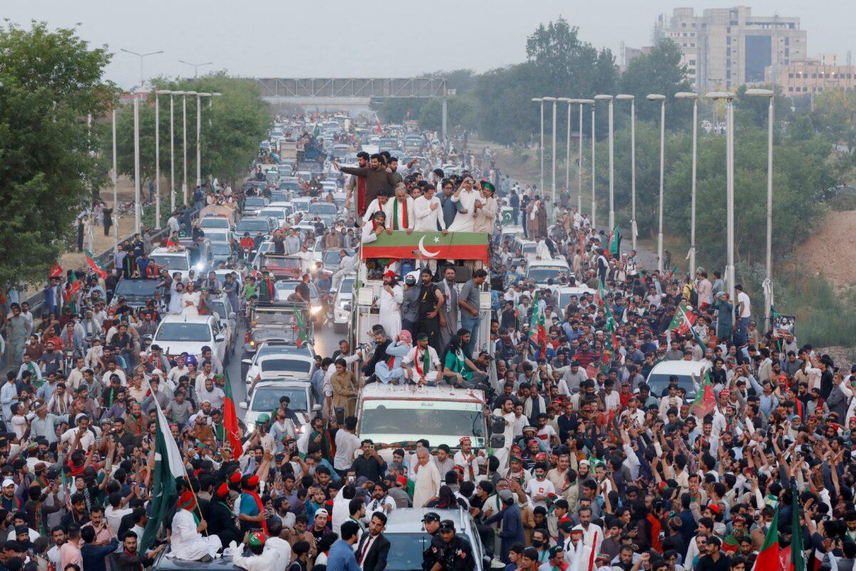 Ousted Pakistani Prime Minister Imran Khan gestures as he travels on a vehicle to lead a protest march in Islamabad on May 26, 2022. (Akhtar Soomro/Reuters)