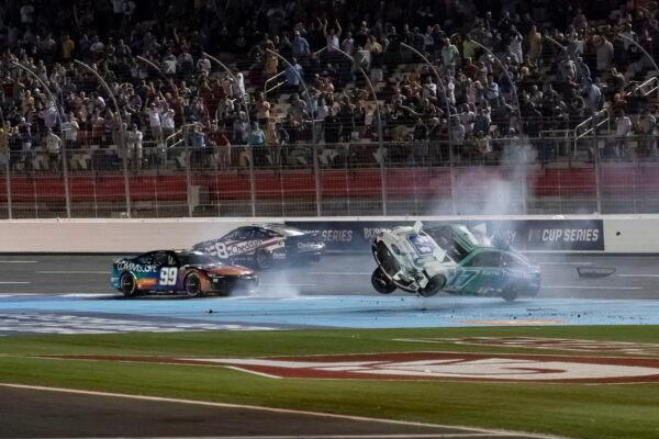 Chris Buescher (17) and Daniel Suarez (99) crash during a NASCAR Cup Series auto race at Charlotte Motor Speedway in Concord, N.C., on May 29, 2022. (Matt Kelley/AP Photo)
