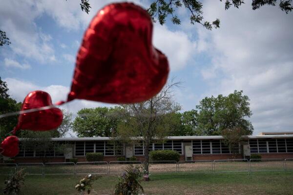A heart-shaped balloon flies decorating a memorial site outside Robb Elementary School in Uvalde, Texas, on May 30, 2022. (Wong Maye-E/AP Photo)