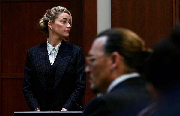 Actors Amber Heard and Johnny Depp, watch the jury arrive in the courtroom at the Fairfax County Circuit Courthouse in Fairfax, Va., on May 17, 2022. (Brendan Smialowski/Pool photo via AP)
