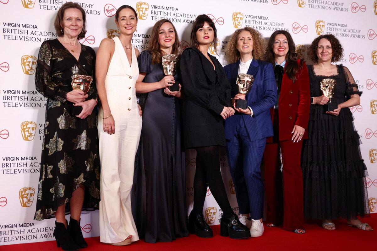 Nerys Evans, Molly Manners, Gabrielle Creevy, Kayleigh Llewellyn, Jo Hartley, and members of the team of "In My Skin" pose with the "Best Drama Series" award at the British Academy Television Awards in London on May 8, 2022. (Henry Nicholls/Reuters)