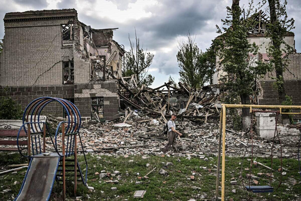 A man walks in front of a destroyed school in the city of Bakhmut, in the eastern Ukrainian region of Donbas, on May 28, 2022, on the 94th day of Russia's invasion of Ukraine. (Aris Messinis/AFP via Getty Images)