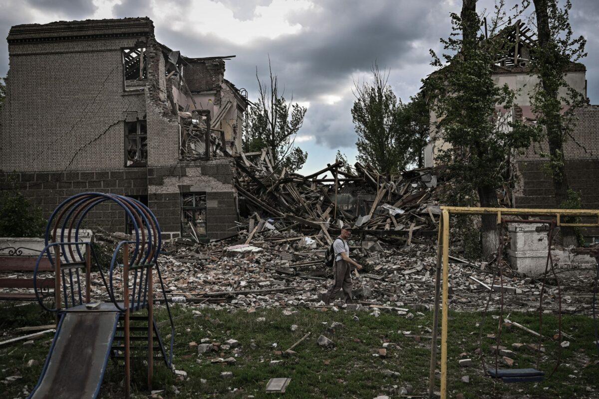 A man walks in front of a destroyed school in the city of Bakhmut, in the eastern Ukranian region of Donbass, on May 28, 2022, on the 94th day of Russia's invasion of Ukraine. (Aris Messinis/AFP via Getty Images)